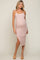 woman wearing a light pink ribbed maternity dress with a side slit and a visible baby bump