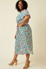 woman wearing a colorful floral plus size midi dress with short sleeves and a cinched waist, paired with strappy heels
