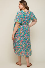 woman wearing a floral print maternity dress with short sleeves and a pleated skirt, showing a baby bump from the back