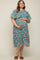 woman wearing a floral print maternity dress with short puff sleeves and holding her baby bump