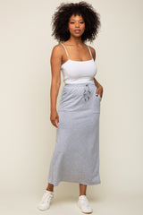 woman wearing a white tank top and a gray maxi skirt with drawstring and pockets