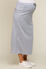 woman wearing a grey maternity maxi skirt with a drawstring waist and visible baby bump