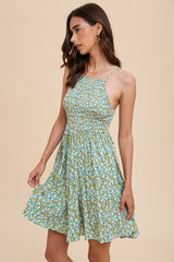 woman wearing a green floral sundress with a fitted bodice and flared skirt