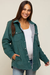 woman wearing a green corduroy maternity jacket with a fleece lining and a visible baby bump