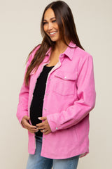 smiling pregnant woman wearing a pink corduroy maternity shacket with sherpa lining over a black top