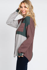 woman wearing a color block corduroy button down shirt in green, brown, and white stripes