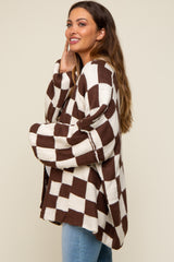 woman wearing a brown and white checkered maternity cardigan with an oversized fit and a relaxed silhouette