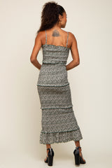 woman wearing a floral print midi dress with ruffle details and spaghetti straps, shown from the back