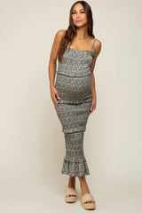 woman wearing a floral print maternity dress with tiered ruffles and adjustable straps, showcasing her baby bump