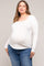 woman wearing a white long sleeve maternity top and showing her baby bump with blue jeans