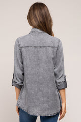 woman wearing a gray denim maternity shirt with rolled-up sleeves, viewed from the back