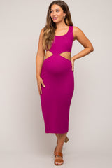 woman wearing a fuchsia cut-out midi maternity dress showcasing a baby bump