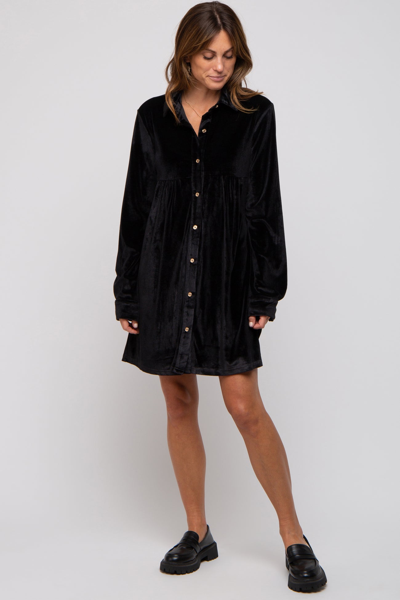 woman wearing a black velvet long sleeve shirt dress with buttons and relaxed fit