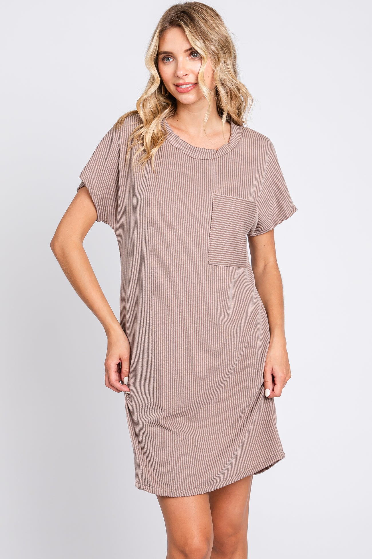 woman wearing a brown and white striped short sleeve dress with a pocket detail