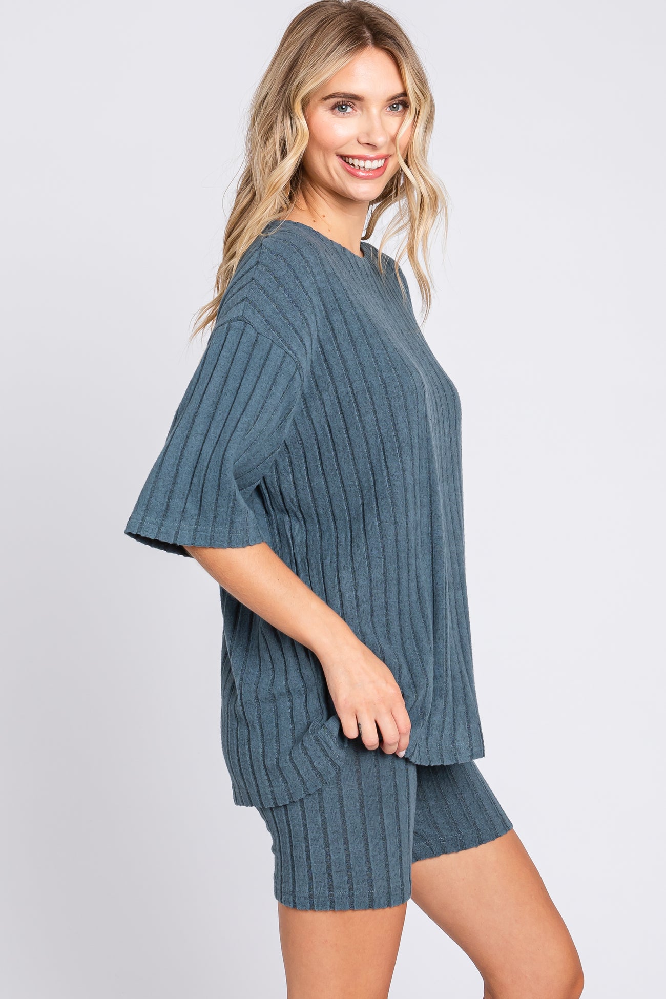 woman wearing a teal ribbed short sleeve top and matching shorts in a relaxed fit