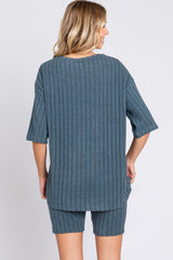 woman wearing a slate blue ribbed short sleeve top and matching shorts from the back