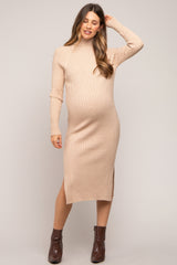 woman wearing a beige ribbed maternity dress with a turtleneck and side slit, showcasing her baby bump