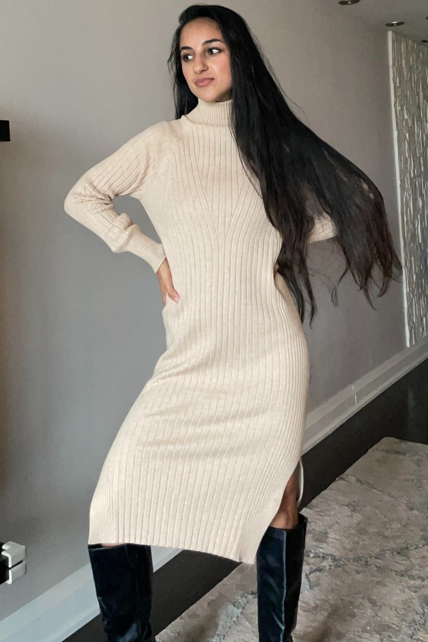 woman wearing a beige ribbed turtleneck midi dress with side slit and long sleeves