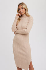 woman wearing a beige ribbed turtleneck midi dress with long sleeves and side slits