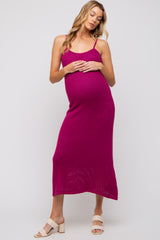 woman wearing a fuchsia ribbed maternity dress with adjustable straps and a visible baby bump