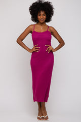woman wearing a fuchsia ribbed midi dress with thin straps and a fitted silhouette