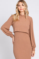 woman wearing a brown ribbed long sleeve dress with a high neck and cropped top design