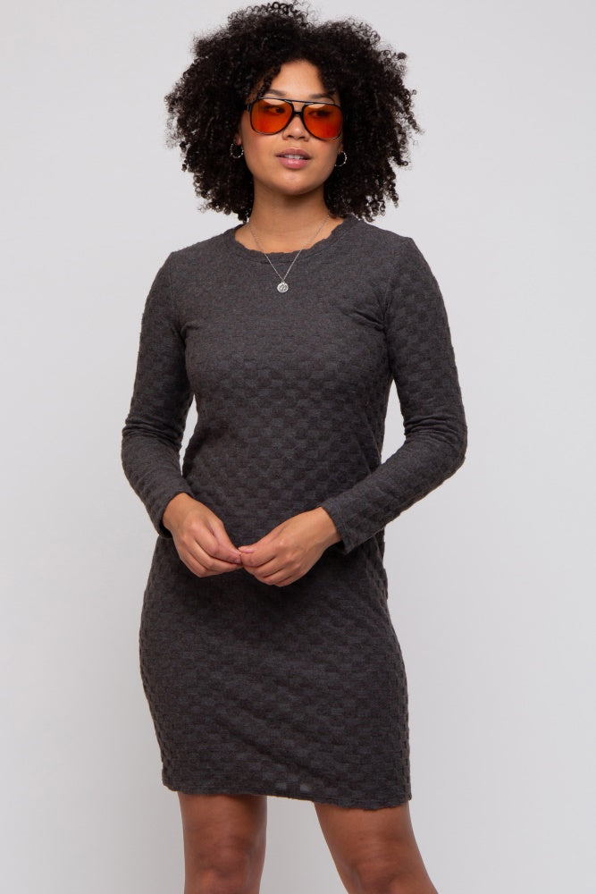 woman wearing a dark gray long sleeve textured dress with a slim fit and round neckline