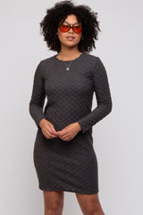 woman wearing a dark gray long sleeve textured dress with a slim fit and round neckline