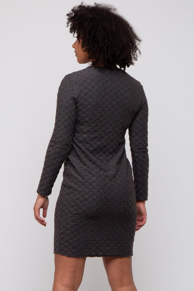 woman wearing a dark gray long sleeve textured dress viewed from the back