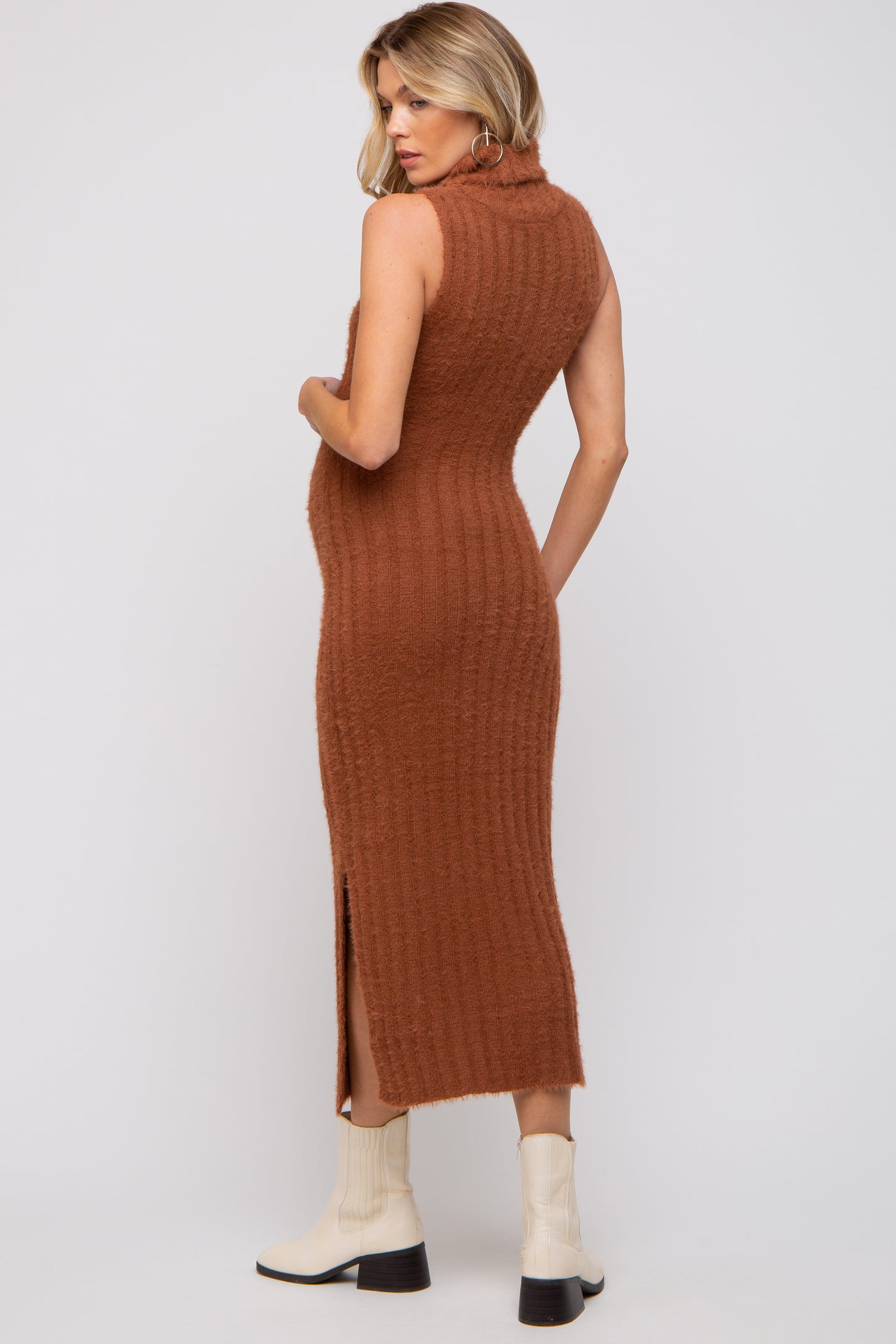 woman wearing a brown ribbed sleeveless midi maternity dress with a side slit and a baby bump