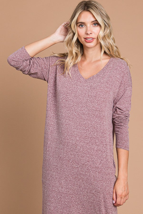 woman wearing a dusty mauve long sleeve v-neck dress with a relaxed fit