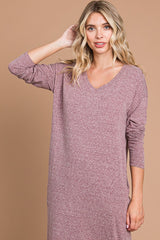 woman wearing a dusty mauve long sleeve v-neck dress with a relaxed fit