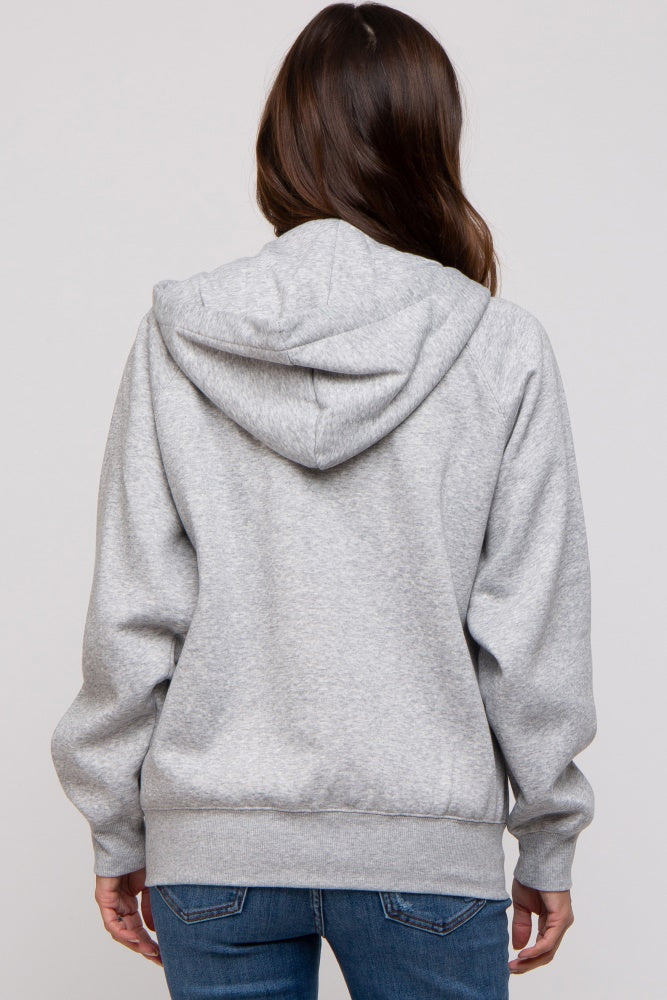 woman wearing a gray maternity hoodie with a hood, viewed from the back, paired with blue jeans