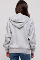 woman wearing a gray maternity hoodie with a hood, viewed from the back, paired with blue jeans
