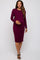 woman wearing a burgundy long sleeve maternity dress, showcasing her baby bump, styled with black sandals