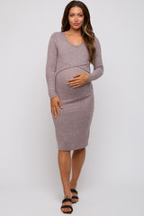woman wearing a light purple long sleeve maternity dress and holding her baby bump