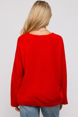 woman wearing a red oversized maternity sweater with a relaxed fit, viewed from the back