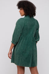 woman wearing a green denim shirt dress with a gathered waist and puffed sleeves, shown from the back