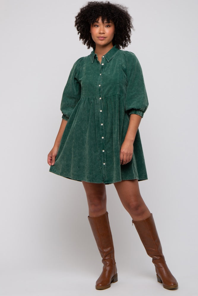 woman wearing a green corduroy button-up dress with puff sleeves and brown knee-high boots