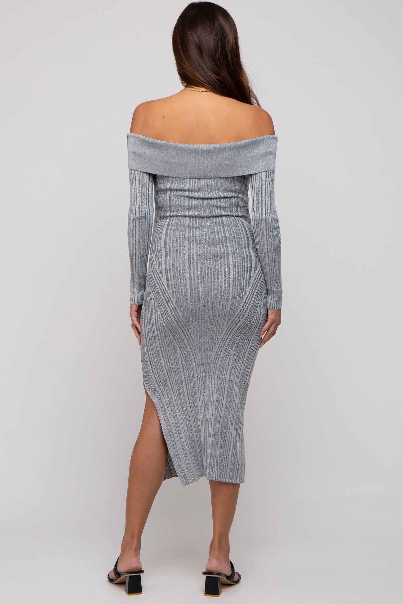 woman wearing a grey off-the-shoulder maternity dress with ribbed texture and a side slit
