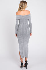 woman wearing a grey off-the-shoulder fitted maxi dress with ribbed detailing and side slit, viewed from the back