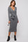 woman wearing a gray long sleeve wrap dress with a tie at the waist and black ankle boots