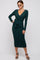 woman wearing a dark green long sleeve wrap dress with a tie at the waist and stiletto heels