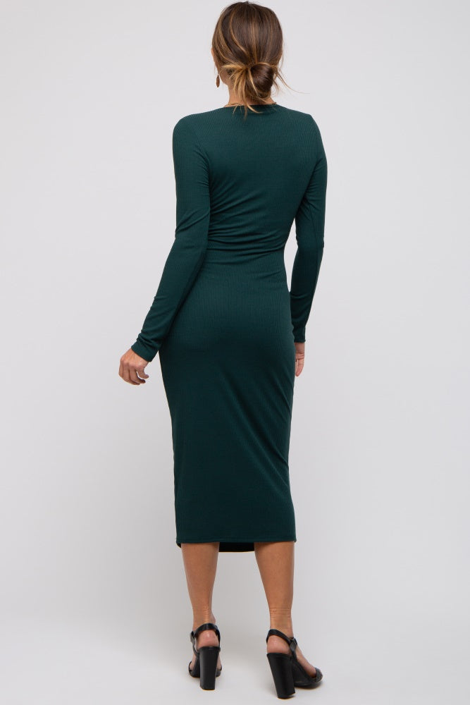 woman wearing a dark green ribbed midi dress with long sleeves and a fitted silhouette, view from the back