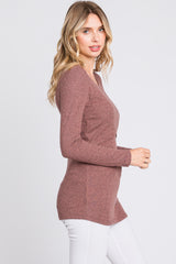 woman wearing a mauve long sleeve knit cardigan with a fitted silhouette paired with white jeans