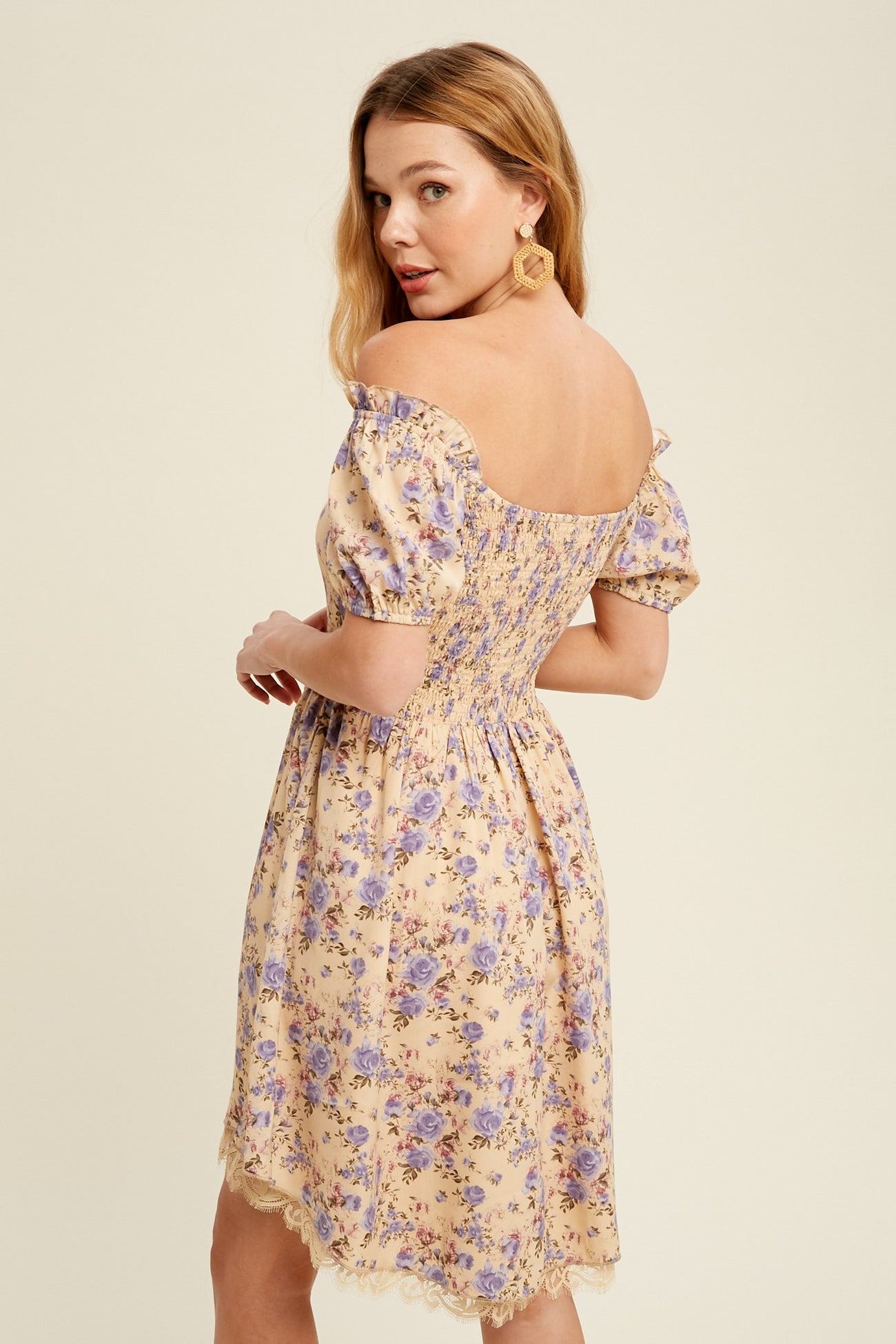 woman wearing a floral off-the-shoulder sundress with puff sleeves and a smocked back detail