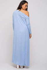 woman wearing a light blue one-shoulder maxi dress with ribbed texture and long sleeves