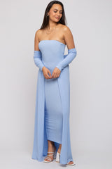 woman wearing a light blue strapless gown with long sleeves and a thigh-high slit