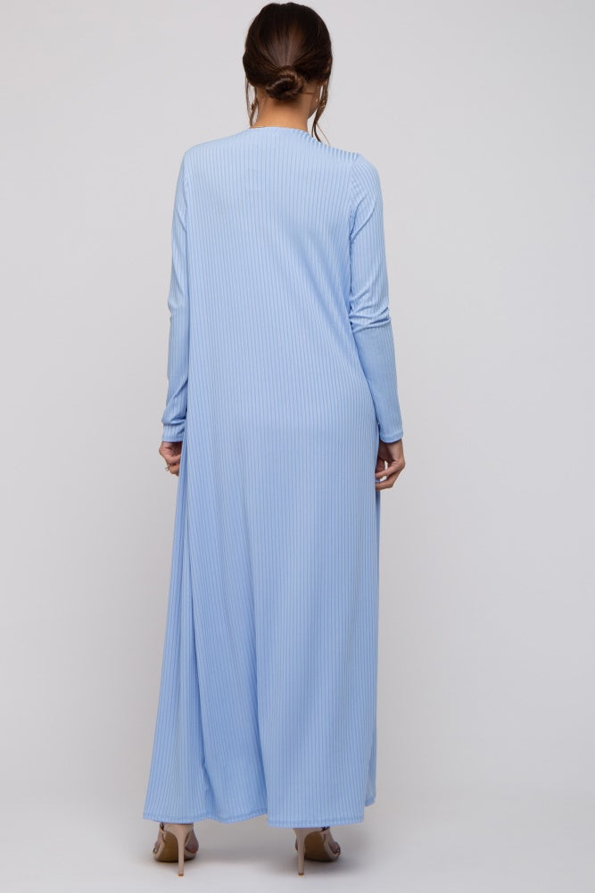 woman wearing a striped light blue maternity maxi dress with long sleeves and a flowy silhouette