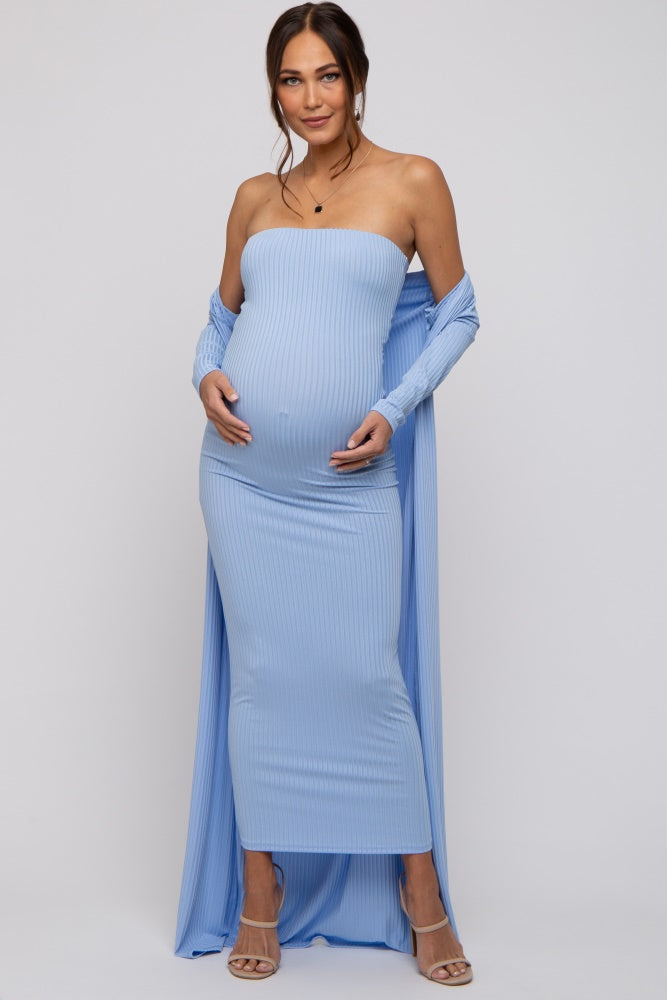 woman wearing a light blue strapless maternity dress with a long open cardigan, showcasing her baby bump